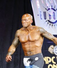 2012 NPC Men's Master's National Physique Competitor John Quinlan on Stage Image 2.jpg