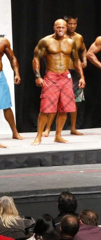 2012 NPC USA National Men's Physique Competitor John Quinlan On Stage Photo.jpg