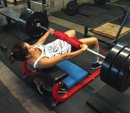 Diana hip thrusting - note the head/neck position which prevents overarching of the spine and encourages slight posterior pelvic tilt.