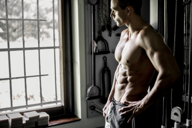 Muscular man visualizing his workout