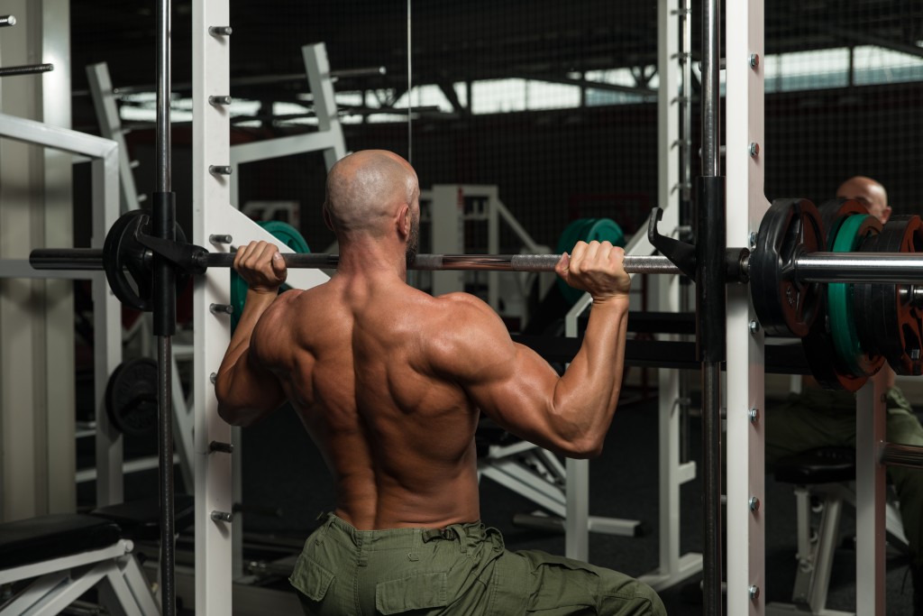 Mature Man Doing Shoulder Exercises In The Gym Mature Man Doing Shoulder Exercises In The Gym